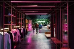 Couple looking directly down hallway in apparel store