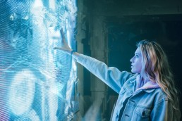 Woman interacting with a interactive touch wall